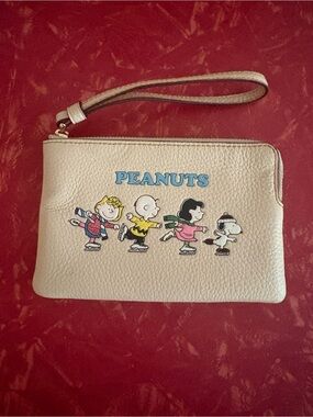 NWOT RARE Coach Cream Peanuts Wristlet with Colorful Snoopy & Friends Motif.